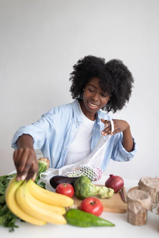 A woman smiling while unpacking fresh groceries